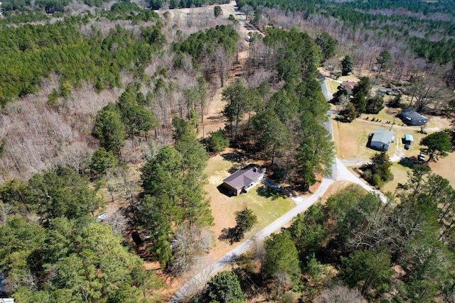 birds eye view of property with a view of trees