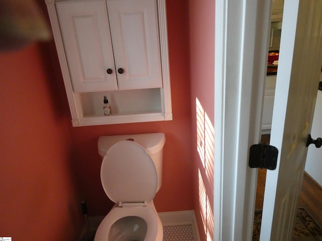 bathroom featuring toilet and baseboards