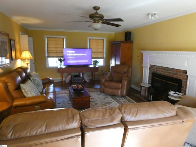 living area featuring a fireplace, wood finished floors, ceiling fan, and ornamental molding