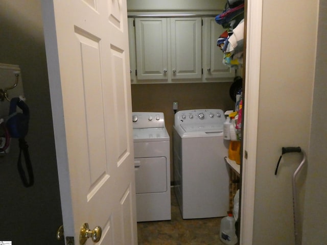 washroom with cabinet space and washing machine and clothes dryer