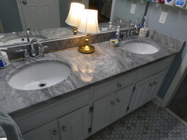 bathroom featuring tile patterned floors, double vanity, and a sink