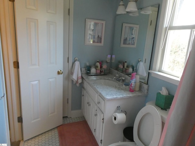 bathroom featuring vanity and toilet