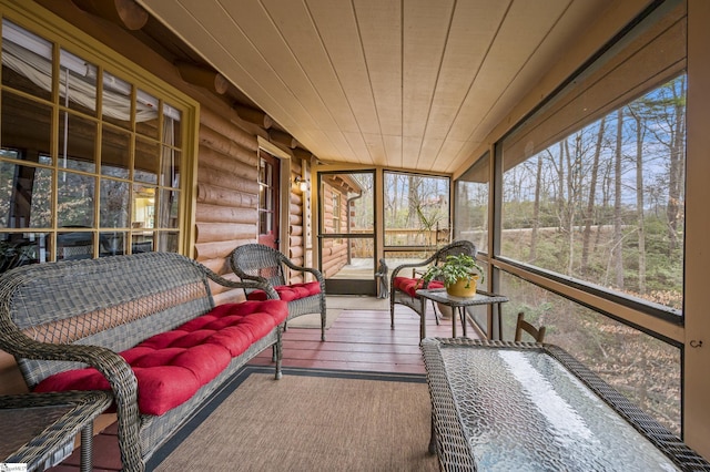 sunroom featuring wood ceiling