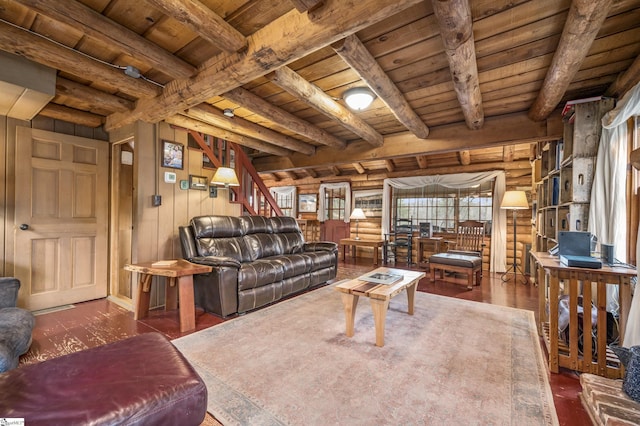 living area with rustic walls, beamed ceiling, wood ceiling, and wood finished floors