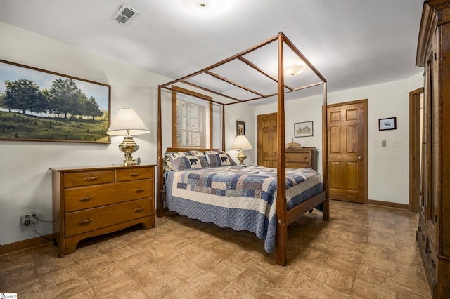 bedroom with visible vents and baseboards