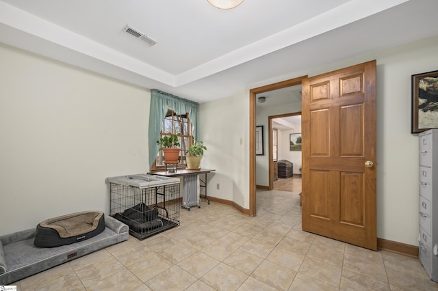 interior space featuring light tile patterned floors, baseboards, and visible vents