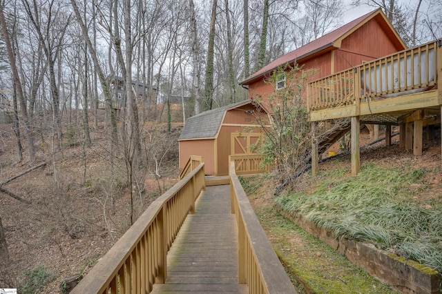 exterior space featuring an outbuilding, a gambrel roof, and a storage shed