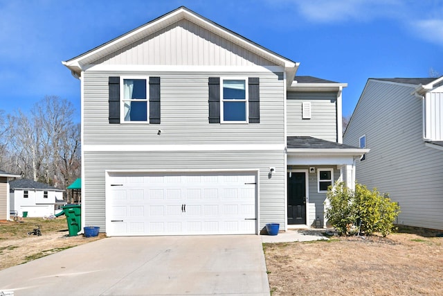 traditional-style house featuring an attached garage and concrete driveway