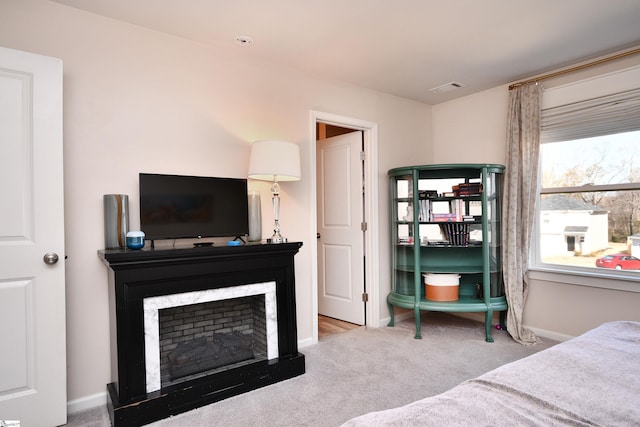 carpeted bedroom featuring baseboards and visible vents