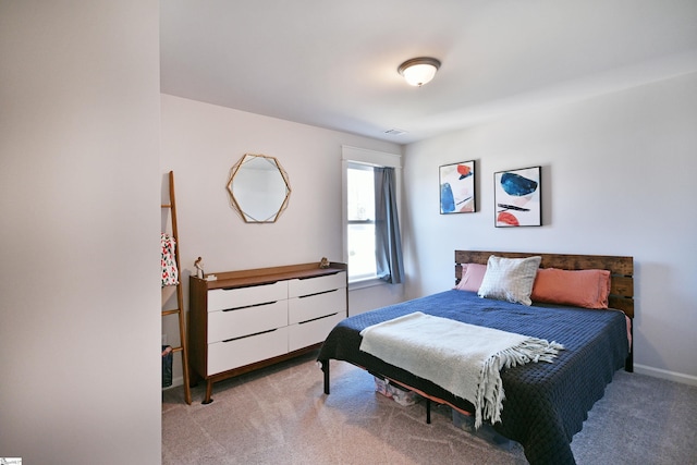 carpeted bedroom with baseboards and visible vents