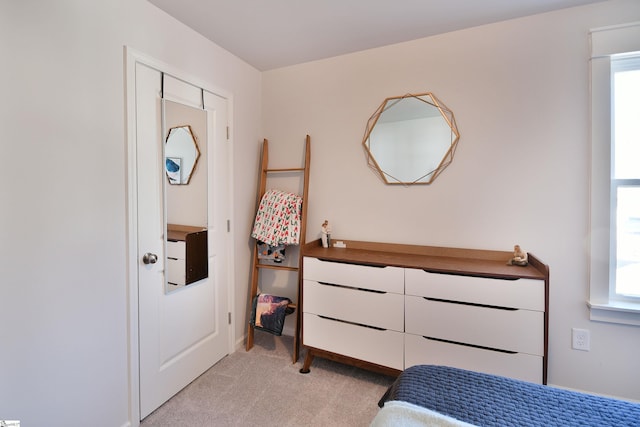 bedroom featuring light colored carpet