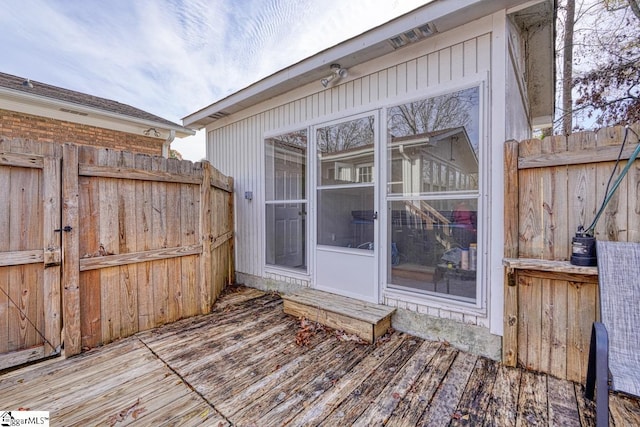 wooden terrace with fence and a sunroom