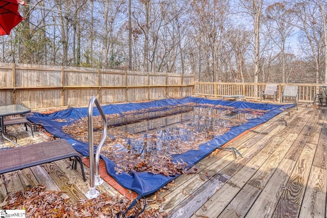 view of pool with a deck and fence