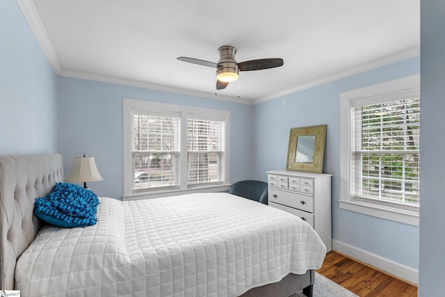 bedroom with baseboards, wood finished floors, a ceiling fan, and ornamental molding