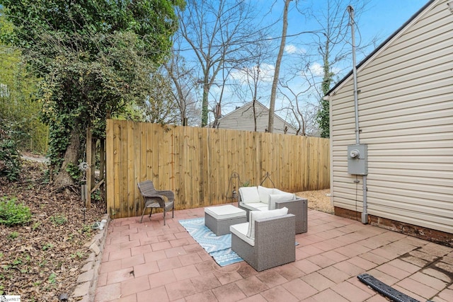 view of patio featuring an outdoor living space and fence