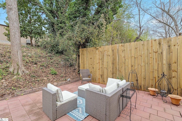 view of patio with an outdoor living space and fence