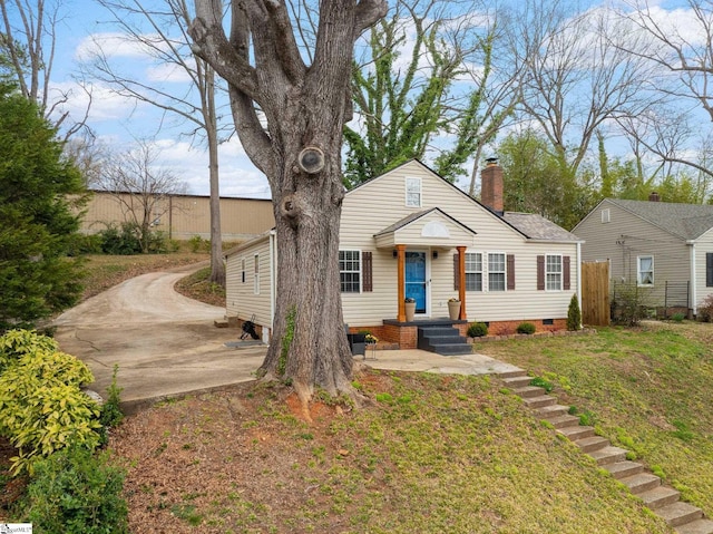 view of front of property with a front yard and a chimney