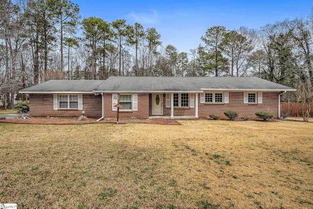 ranch-style home with a front yard and brick siding