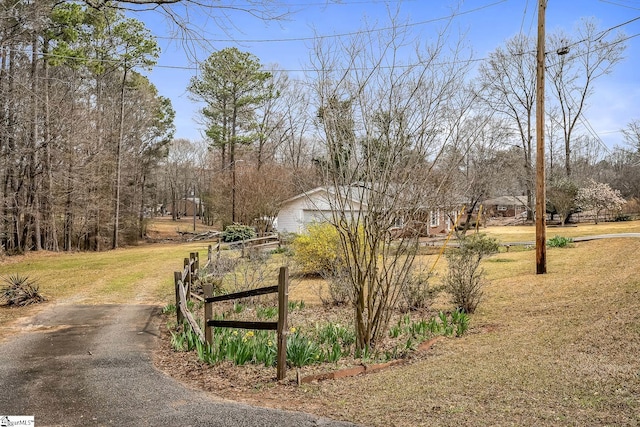 view of home's community with a yard and driveway