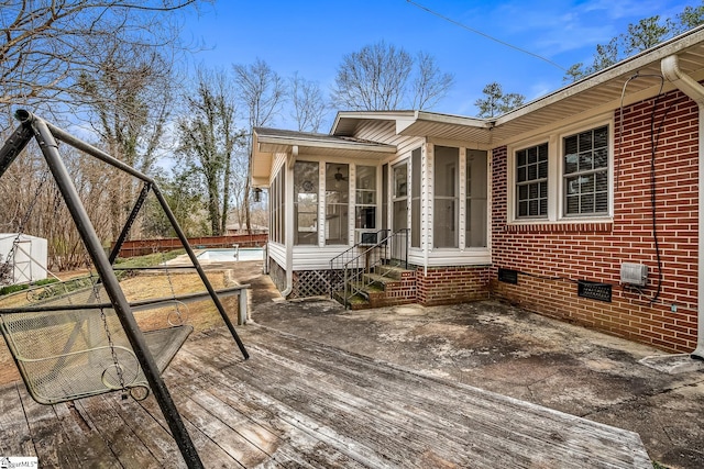 wooden deck with a sunroom