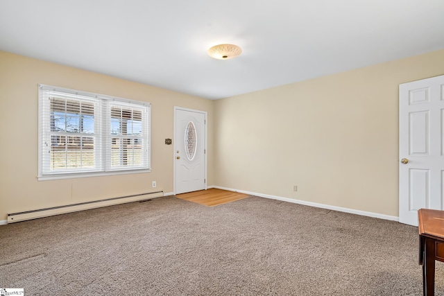 carpeted foyer featuring a baseboard heating unit and baseboards