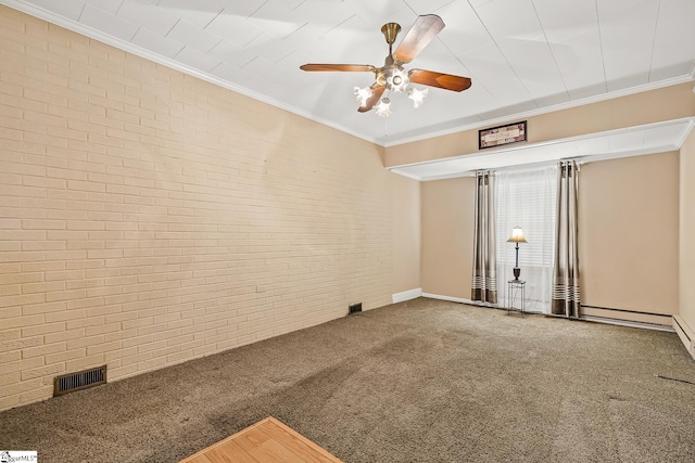 empty room featuring carpet flooring, visible vents, brick wall, and ornamental molding