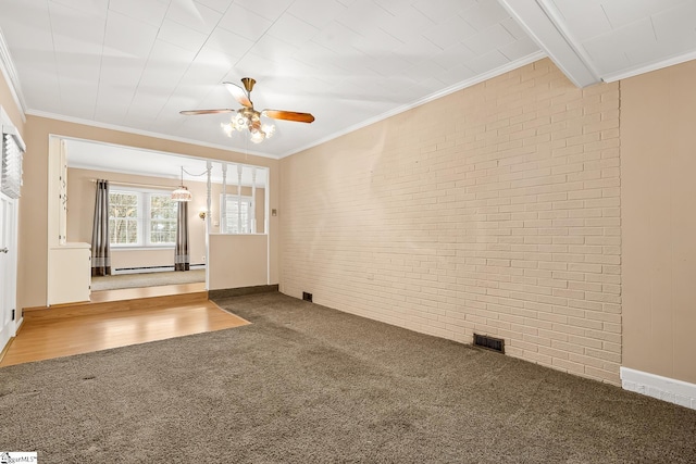 unfurnished living room featuring carpet, visible vents, brick wall, ornamental molding, and ceiling fan