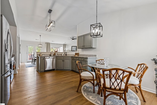 dining room with vaulted ceiling, baseboards, dark wood-style flooring, and a chandelier