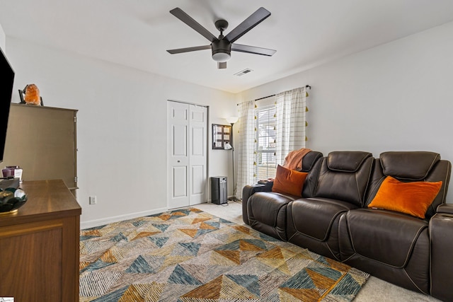 living area with baseboards, light colored carpet, visible vents, and ceiling fan