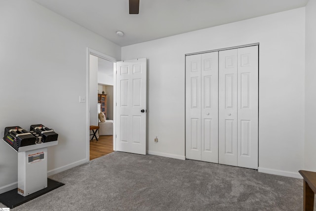 carpeted bedroom featuring a closet, a ceiling fan, and baseboards