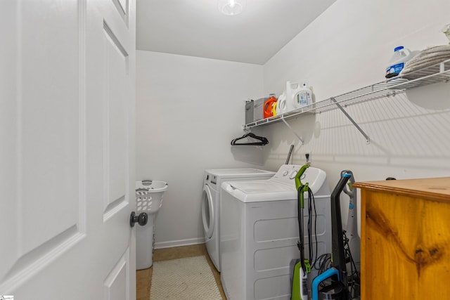 laundry area with washing machine and clothes dryer, laundry area, and baseboards