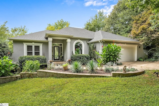 view of front of house with a shingled roof, a front lawn, concrete driveway, stucco siding, and an attached garage