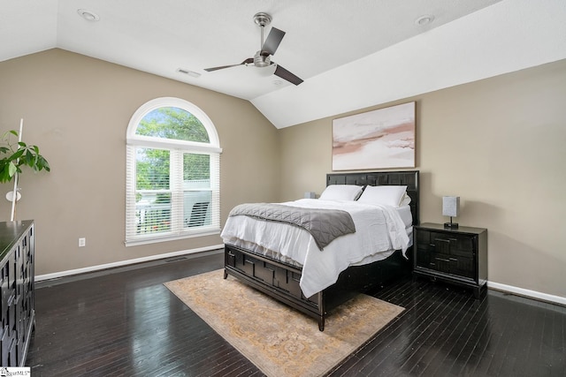 bedroom with visible vents, lofted ceiling, dark wood-type flooring, and baseboards