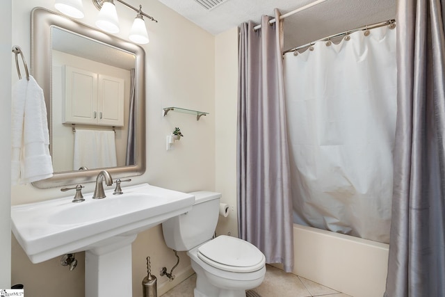 bathroom featuring a sink, toilet, shower / bath combo, and tile patterned flooring