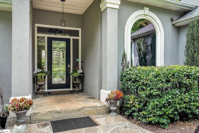 property entrance with stucco siding