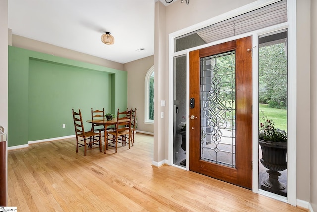 entryway with baseboards and wood finished floors