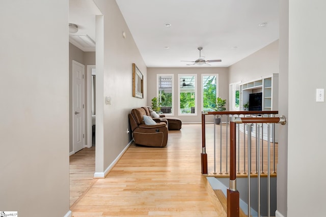 hallway featuring light wood-type flooring and baseboards