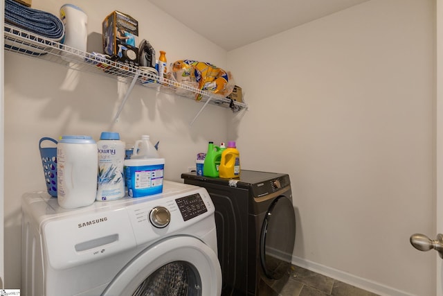 laundry area featuring baseboards, washing machine and dryer, and laundry area