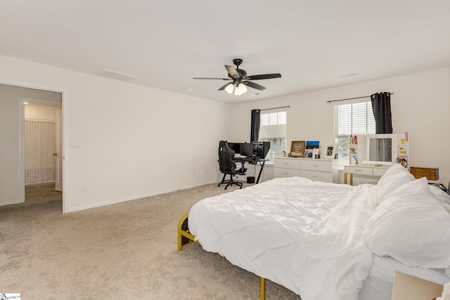 bedroom with ceiling fan, baseboards, and light carpet