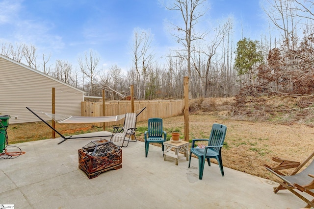 view of patio featuring a fire pit and fence