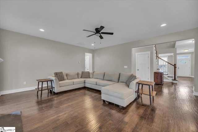 living room featuring stairway, baseboards, recessed lighting, ceiling fan, and dark wood-type flooring