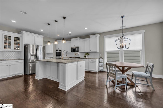 kitchen with a chandelier, dark wood-style floors, appliances with stainless steel finishes, and a sink