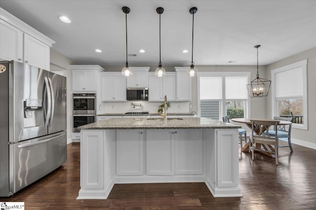 kitchen with backsplash, white cabinets, stainless steel appliances, and dark wood-style flooring