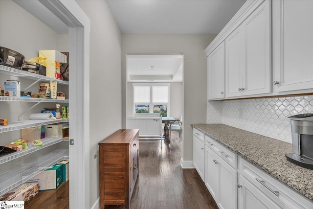 kitchen with dark wood-style floors, decorative backsplash, and white cabinets