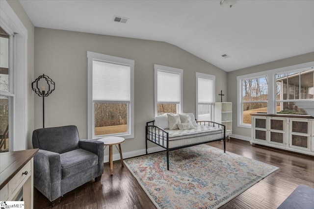 sitting room with visible vents, baseboards, lofted ceiling, and dark wood-style flooring