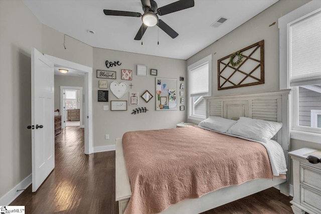 bedroom featuring visible vents, baseboards, dark wood-type flooring, and a ceiling fan