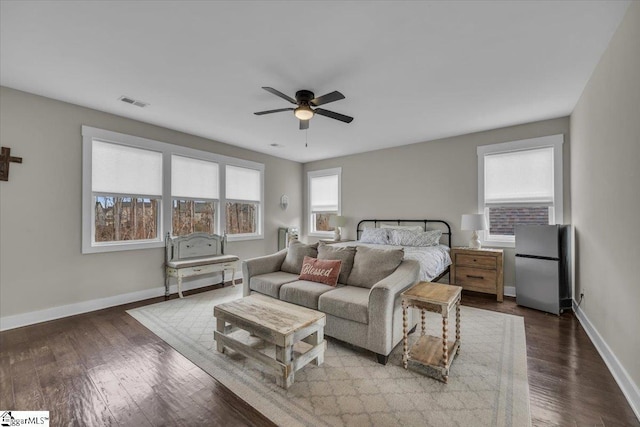 bedroom featuring baseboards, dark wood-style floors, a ceiling fan, and freestanding refrigerator