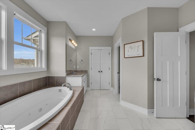 bathroom with baseboards, a whirlpool tub, recessed lighting, marble finish floor, and vanity