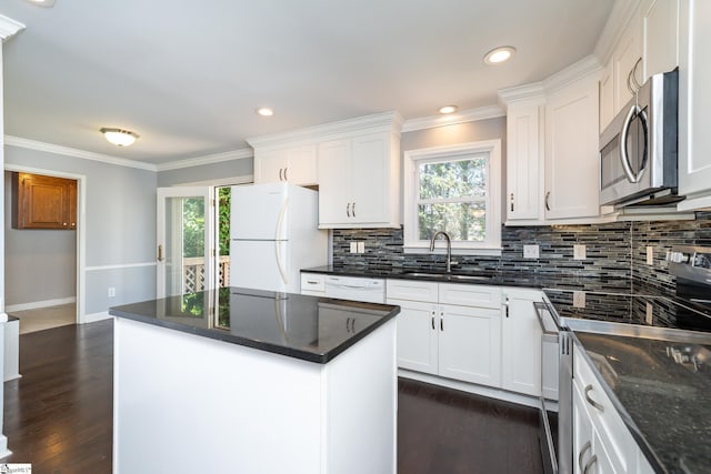 kitchen featuring backsplash, white cabinets, stainless steel appliances, and dark wood-type flooring