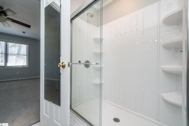 full bathroom with a shower stall, baseboards, and ceiling fan